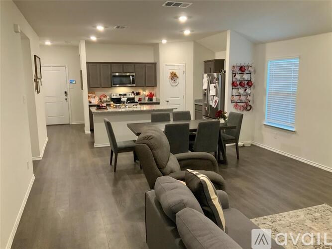 A modern kitchen with a dining table and chairs.