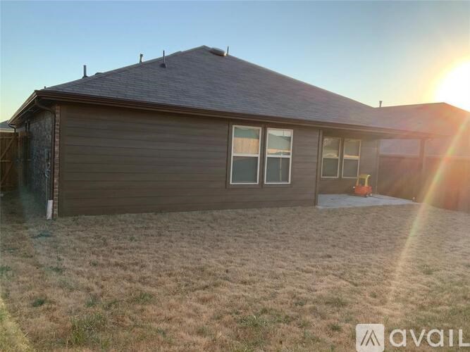 A house with a brown roof and a garage door is available for purchase.