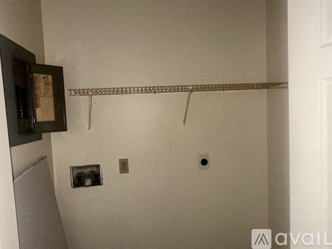 A wall with a shelf and two switches.
