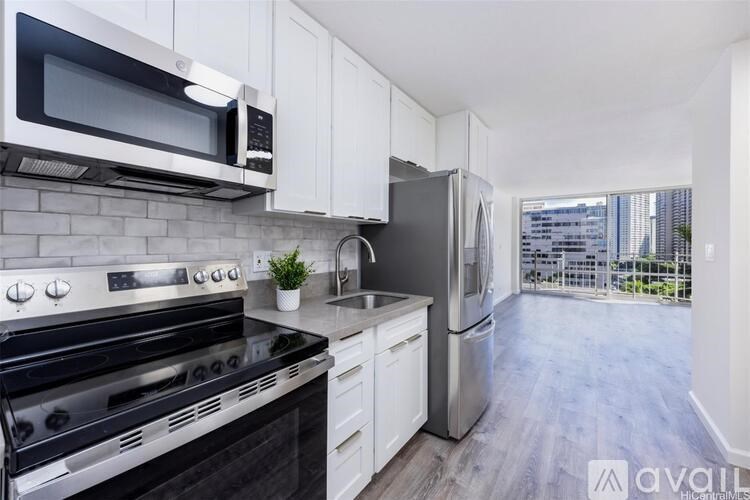 A modern kitchen with stainless steel appliances and white cabinets.