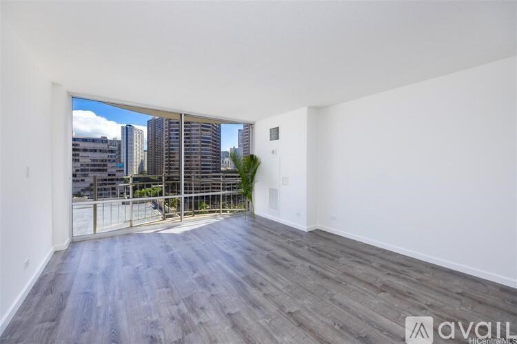 A room with a view of the city through a large window.