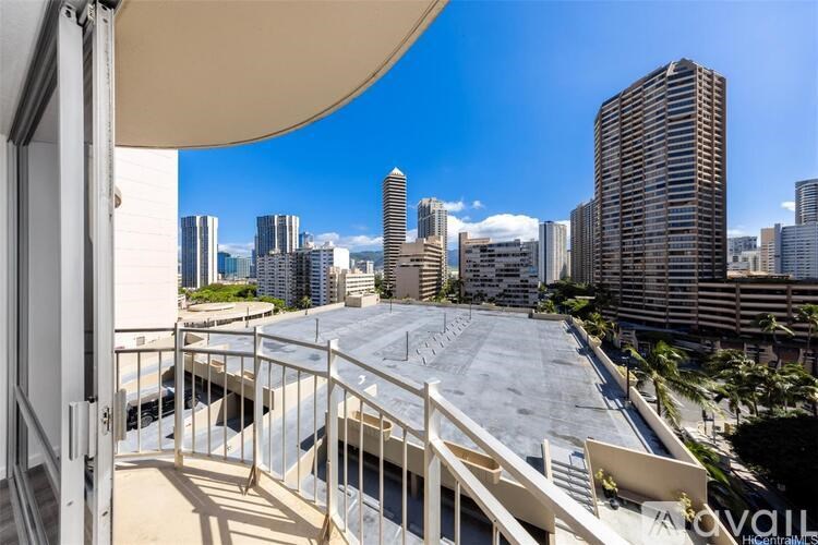 A balcony overlooks a cityscape with tall buildings.