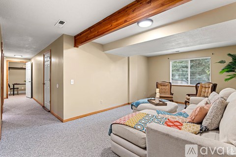 A living room with a couch and a chair.