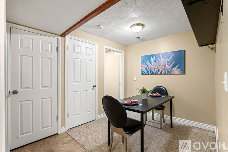 A dining room with a table and chairs.