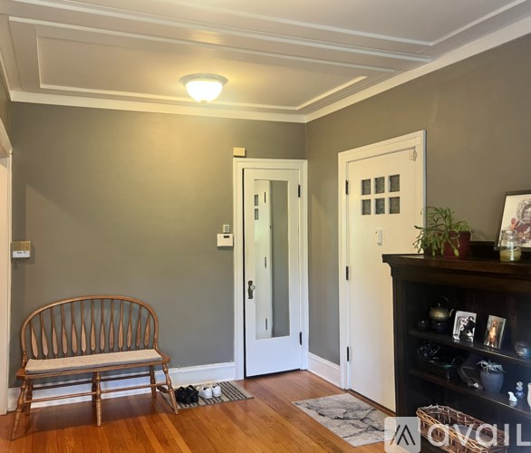 A room with a wooden bench and a fireplace.