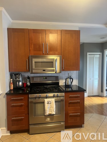 A kitchen with wooden cabinets and a black countertop.