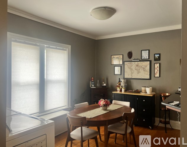 A kitchen with a table and chairs in front of a window.