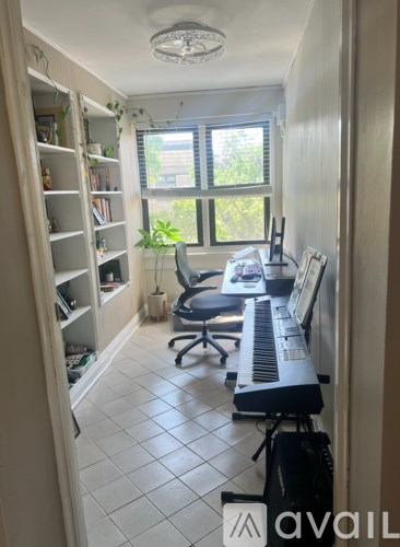 A room with a piano and a chair.