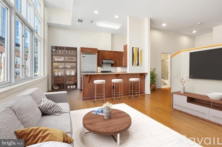 A modern living room with a grey sofa and a wooden coffee table.