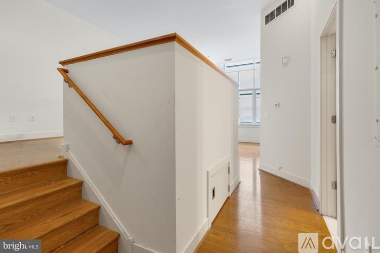 A staircase with wooden steps and a wooden handrail.