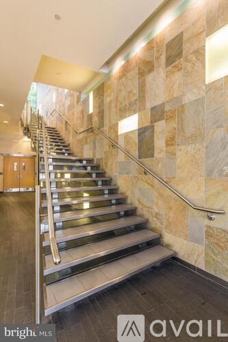A staircase with a metal handrail and wooden steps.