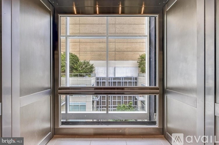 A view from inside a building looking out to a cityscape through a large window.