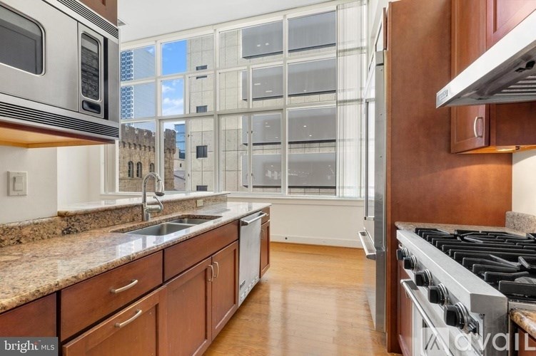 A kitchen with a stove top oven and a microwave.