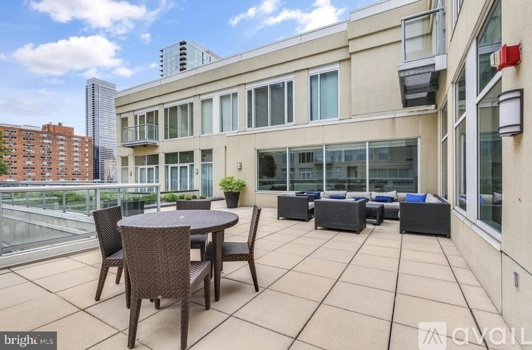 A patio with a table and chairs is set up on a balcony.