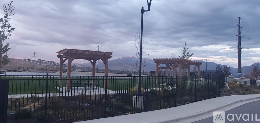A wooden structure sits in the middle of a grassy area.