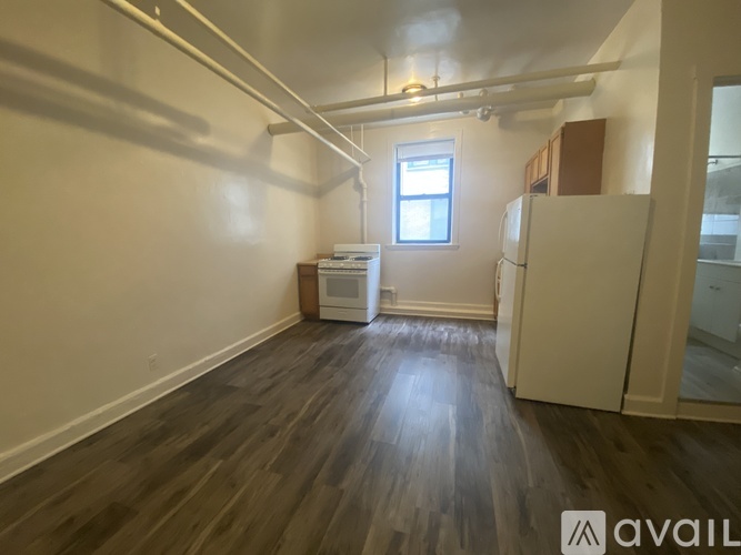A room with wooden floors and a window.