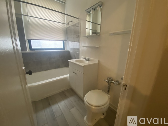 A small bathroom with a toilet, sink, and bathtub.