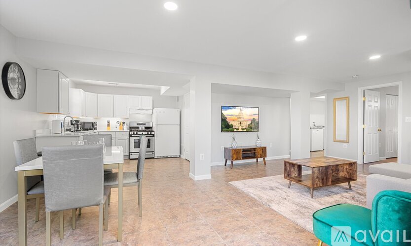 A modern kitchen with a dining table and chairs.
