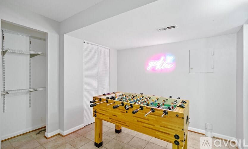 A foosball table sits in a room with white walls and a white ceiling.