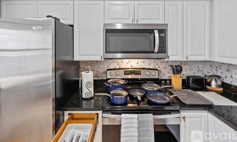 A kitchen with a stove top oven and a microwave above it.