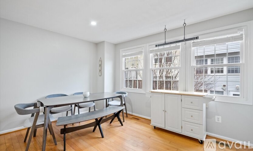 A dining room with a table and chairs.