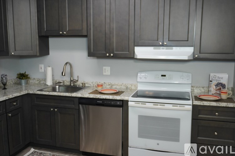 A kitchen with a white oven and black cabinets.