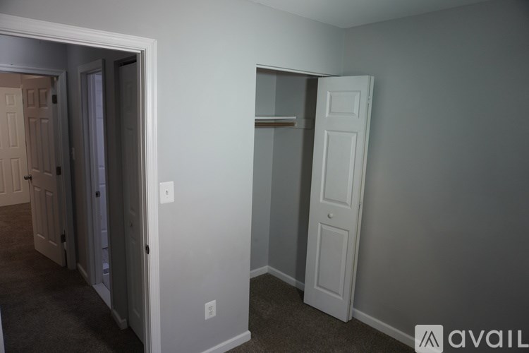 A room with two white doors, one of which is open.