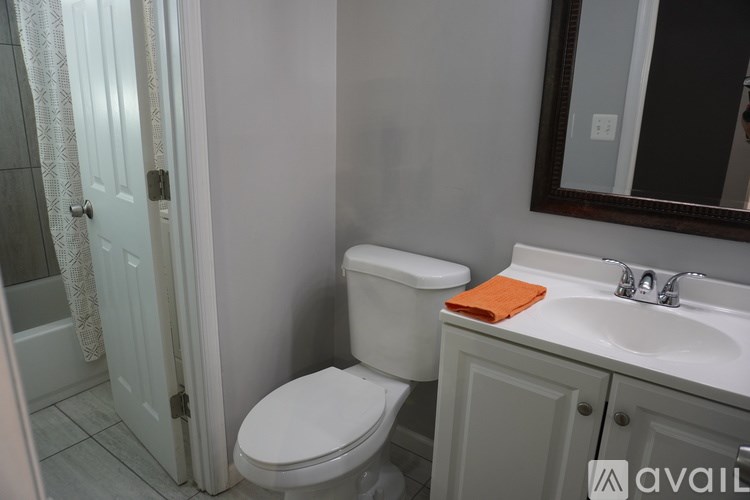 A white toilet sits next to a sink in a bathroom.