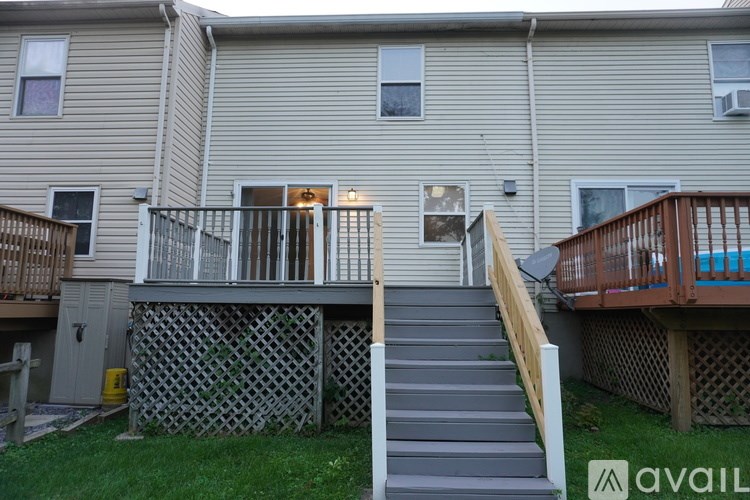 A two-story apartment building with a staircase leading to the second floor.
