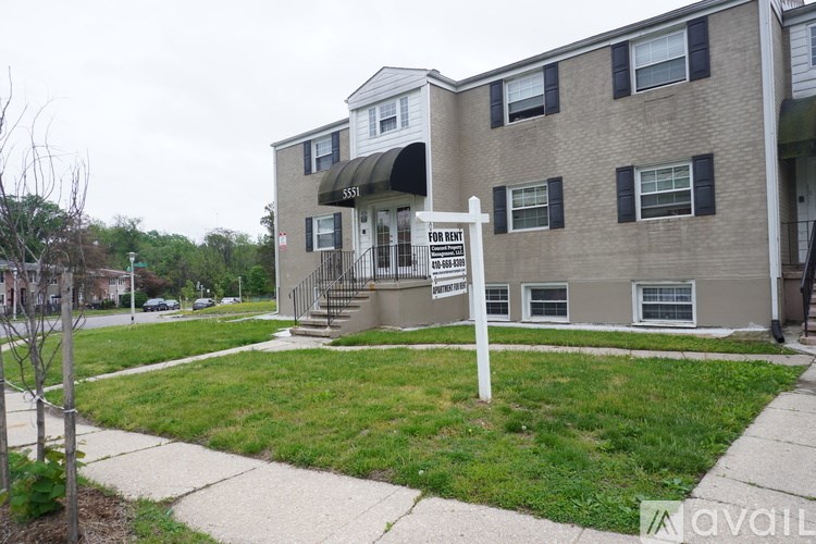 A building with a for lease sign in front of it.