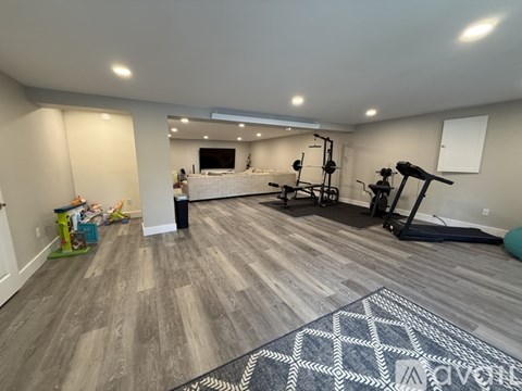 A spacious room with a gym equipment set up.