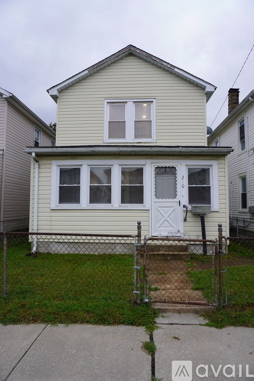 A two-story house with a white door and windows.