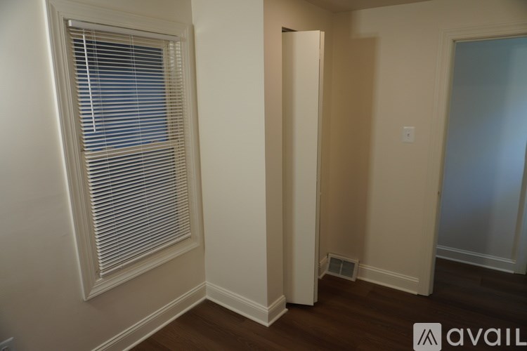 A room with a window and a door.