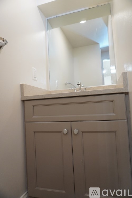 A bathroom vanity with a mirror above it.