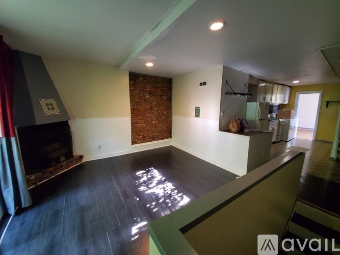 A room with a fireplace and a brick wall.