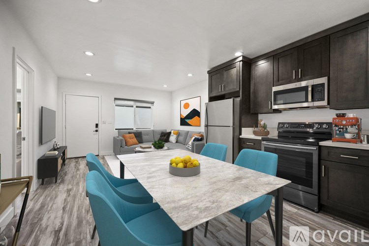 A modern kitchen with a dining table and chairs.