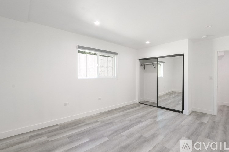 A spacious room with a sliding glass door and a window.