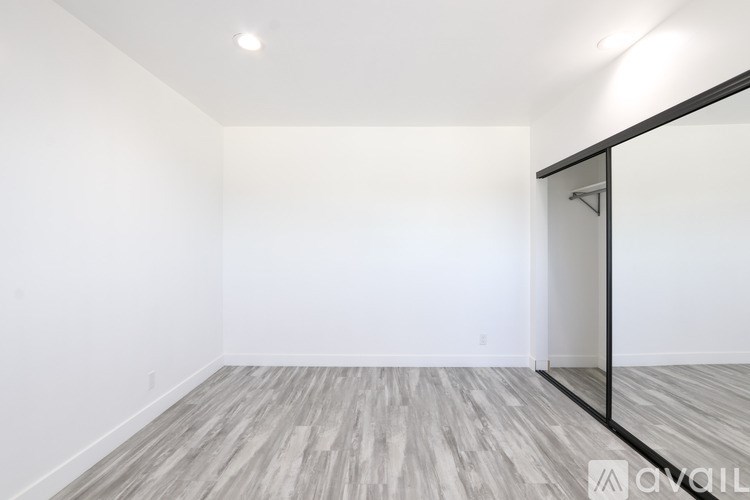 A room with a wooden floor and a glass door.