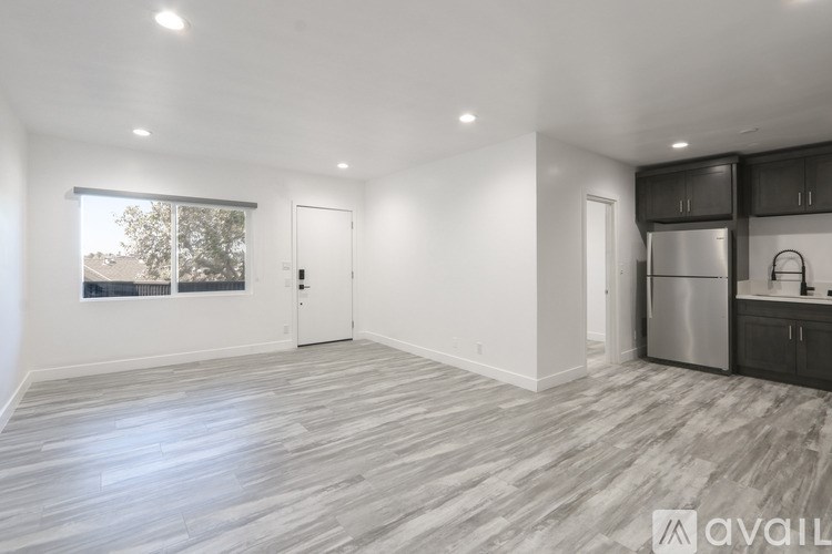 A spacious kitchen with a refrigerator, microwave, and oven.