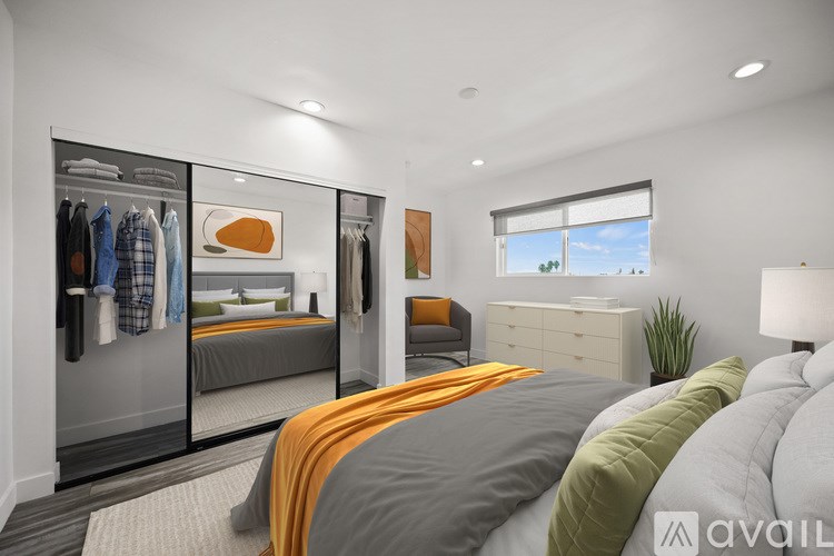 A bedroom with a large bed and a wardrobe.