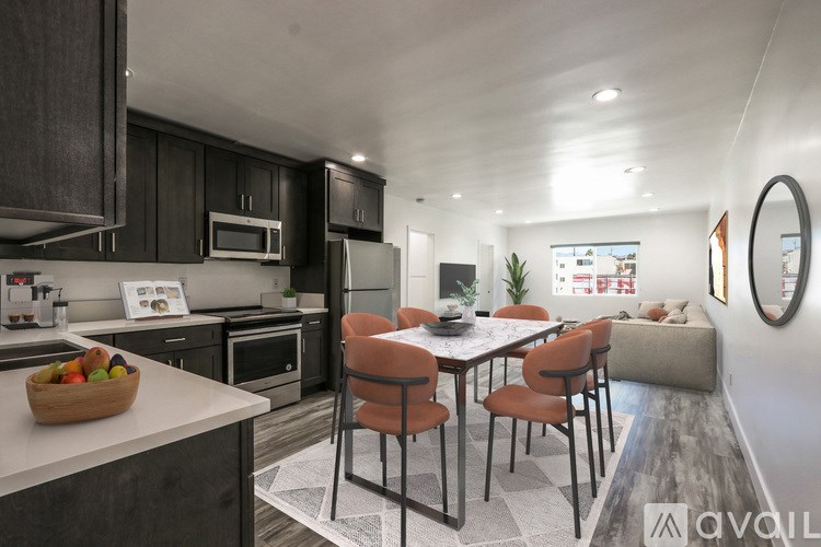A modern kitchen with a dining table set for four.