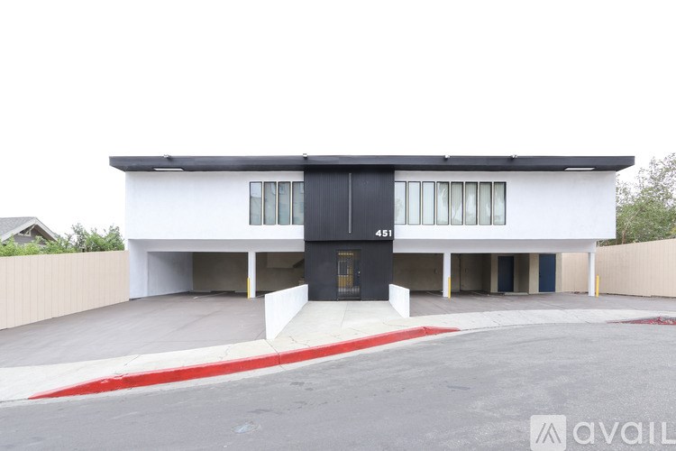 A modern two-story house with a black front door and windows.