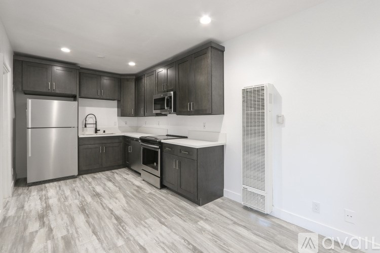 A kitchen with dark wood cabinets and a white countertop.