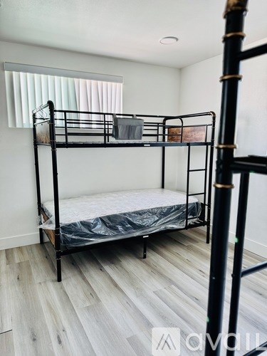 A bunk bed with a mattress on top and a ladder on the side.