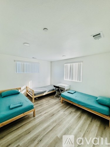 A room with two beds and a table.