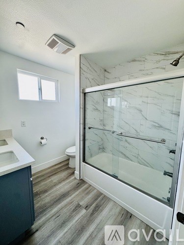 A bathroom with a walk-in shower and a toilet.