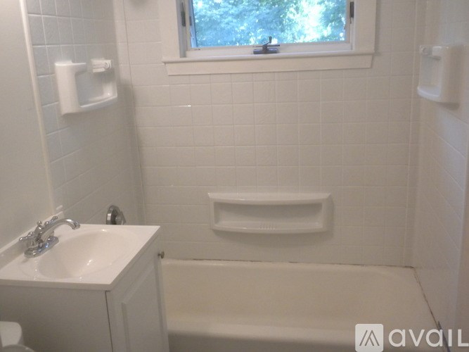 A white bathroom with a sink, toilet, and bathtub.