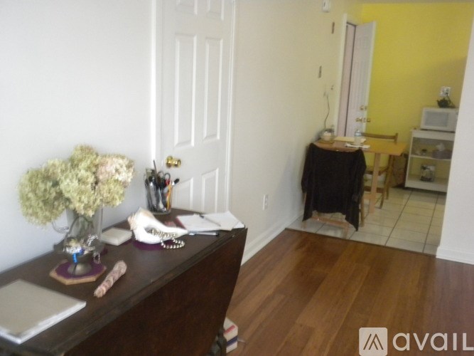 A room with a desk and a laptop on it.