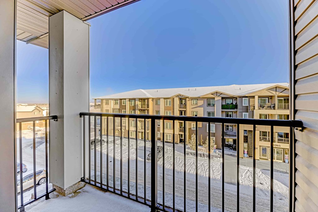 A view of a snowy courtyard from a balcony.