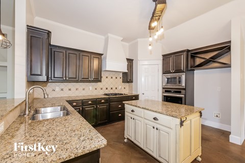 A kitchen with granite countertops and a sink.